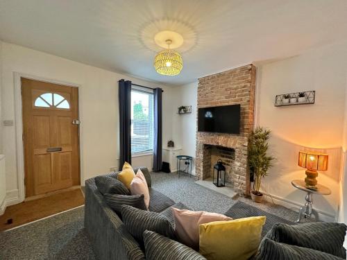 a living room with a couch and a fireplace at Waterloo Street in King's Lynn