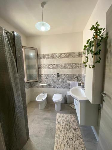 a bathroom with a toilet and a sink and a shower at Tramonto sulle Isole in Marsala