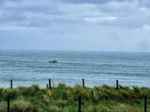 a boat in the ocean on the water at Portrush by the Sea - 6 Dunluce Park in Portrush