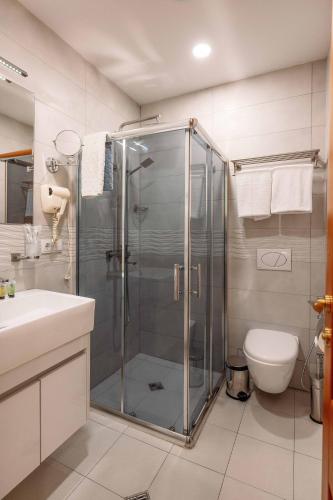 a bathroom with a shower and a toilet at Atrium Boutique Hotel in Tbilisi City