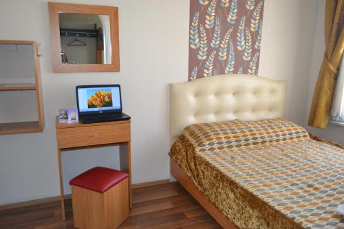 a bedroom with a bed and a table with a mirror at Second Home Hostel in Istanbul