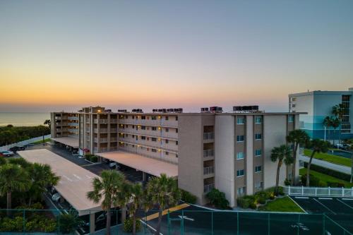 an aerial view of a hotel with the ocean in the background at Cocoa Beach Towers in Cocoa Beach