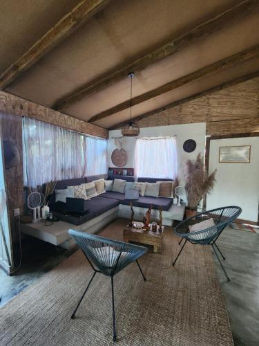 a living room with a couch and a table and chairs at Saona lodge in Mano Juan