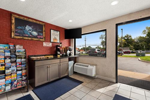 a coffee shop with a counter and a window at Americas Best Value Inn Laurel in Laurel