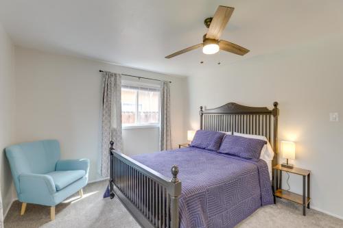 een slaapkamer met een bed en een blauwe stoel bij Grand Junction Home with Deck about 2 Mi to Downtown! in Grand Junction