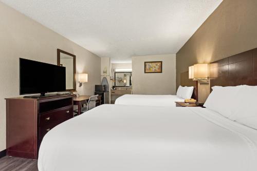 a hotel room with two beds and a flat screen tv at Americas Best Value Inn Laurel in Laurel