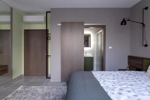 a bedroom with a large bed and a bathroom at LUONG Europe Apartments in Prague