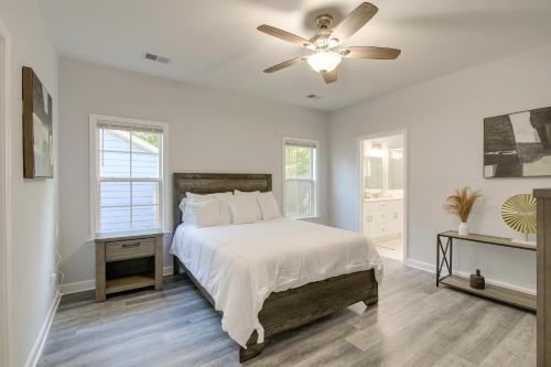 a white bedroom with a bed and a ceiling fan at Sunny Memphis Home about 2 Mi to Beale Street! in Memphis
