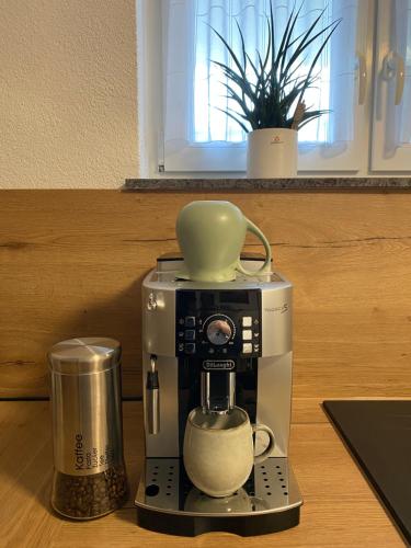 a coffee maker with a cup on top of it at Gemeinsame Zeit in Appenweier