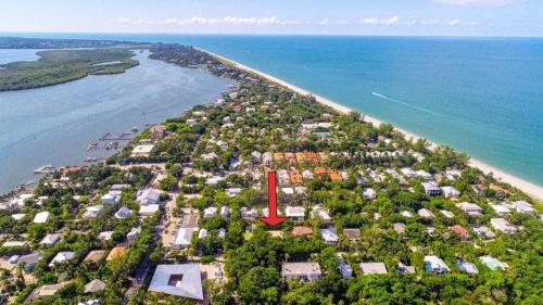 an aerial view of an island with a red arrow at Dancing Dolphin home in Captiva