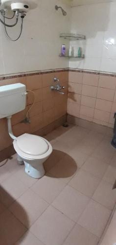 a bathroom with a white toilet and a shower at Service Apartment at Brookefield in Bangalore