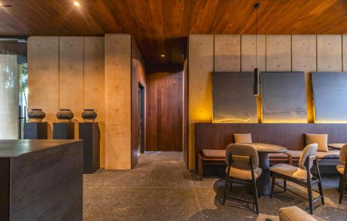 a restaurant with wooden walls and tables and chairs at ONTO Tonalá Mexico City in Mexico City