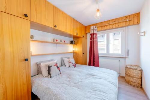 a bedroom with a large bed and a window at Cosy Centered with Garden and View in Veysonnaz in Veysonnaz