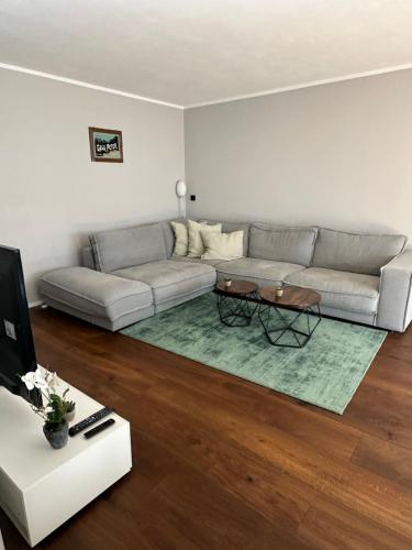 a living room with a couch and a table at City Living Apartment München in Munich