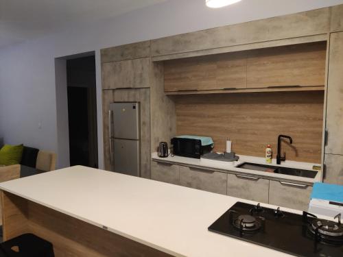 a kitchen with a white counter top and a sink at Ashiana OceanSide Apartment in Flic-en-Flac