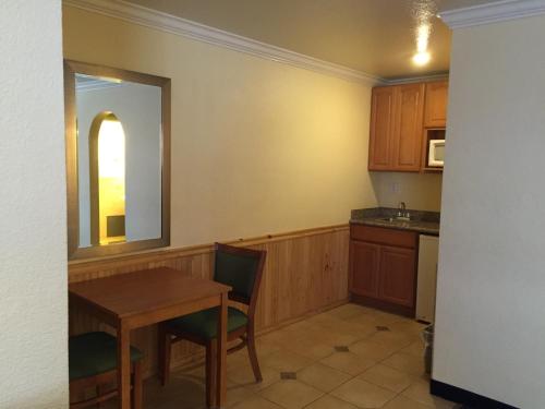 a small kitchen with a table and a mirror at Surf Motel in San Francisco