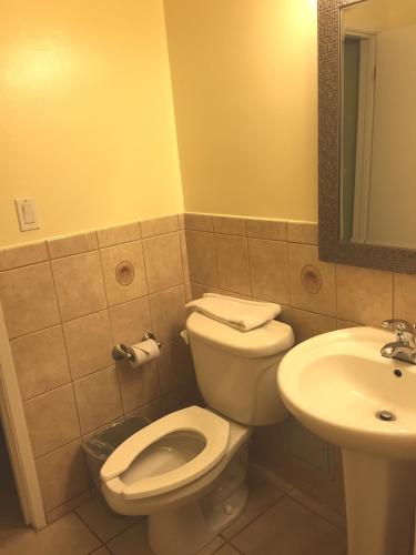 a bathroom with a toilet and a sink at Surf Motel in San Francisco