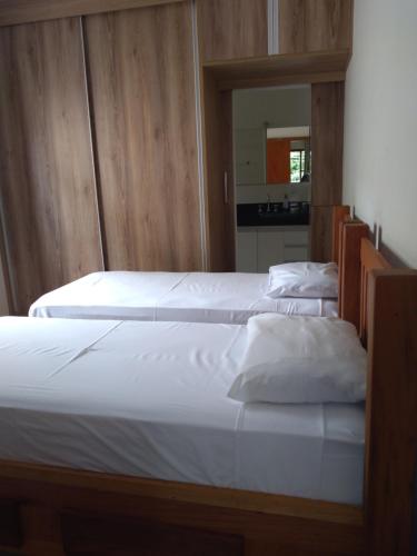 two beds sitting next to each other in a bedroom at SERRA NEGRA TEMPORADA in Serra Negra