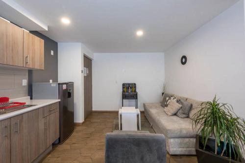 a living room with a couch and a kitchen at Departamento completo en el centro de CDMX in Mexico City