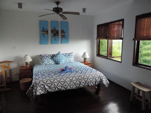 a bedroom with a bed with a stuffed animal on it at Villa Penyon in Nusa Lembongan