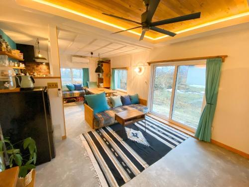 a living room with a couch and a large window at Kojohama base - Vacation STAY 89929v in Shikyū