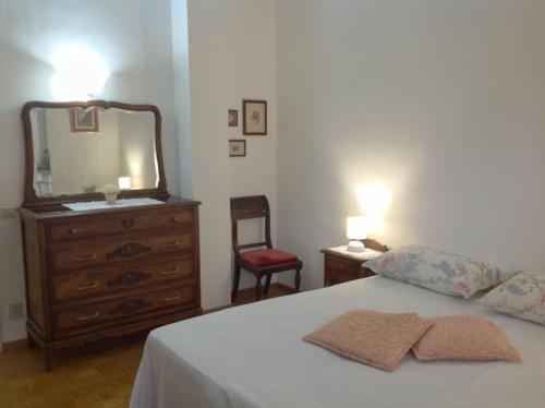 a bedroom with a bed with a dresser and a mirror at Relax time in Biella