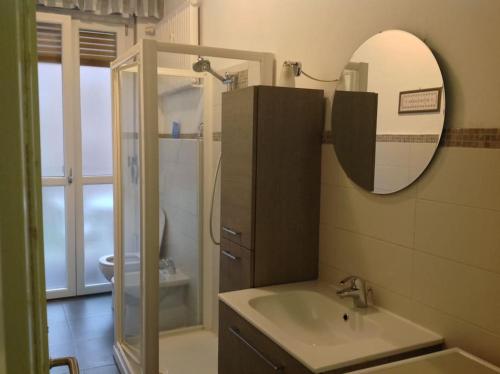 a bathroom with a sink and a mirror and a shower at Relax time in Biella