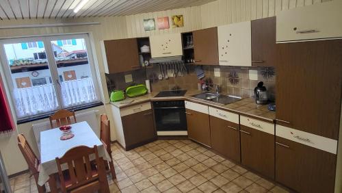 a small kitchen with a table and a table and chairs at Haus Adelheid in Weil am Rhein