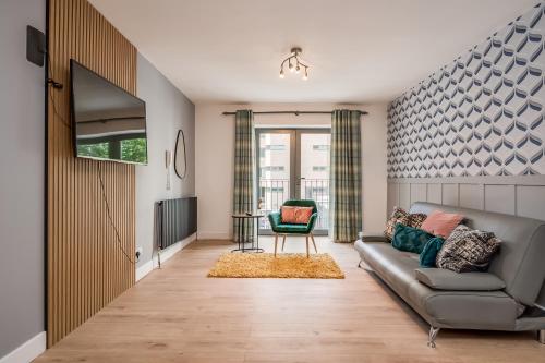 a living room with a couch and a chair at Citygate Central Apartments in Belfast