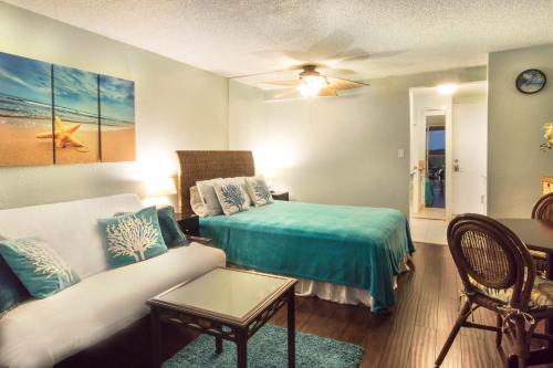 a living room with a couch and a bed at Island Colony 4309 - 30-Night Minimum in Honolulu