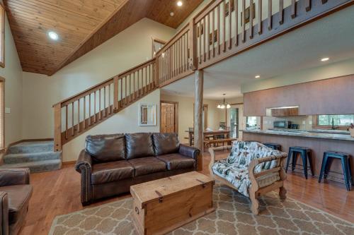a living room with a couch and a table at 2 Mi to Silver Dollar City! Spacious A-Frame Home in Branson