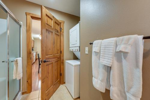 a bathroom with white towels hanging on a rack at 2 Mi to Silver Dollar City! Spacious A-Frame Home in Branson