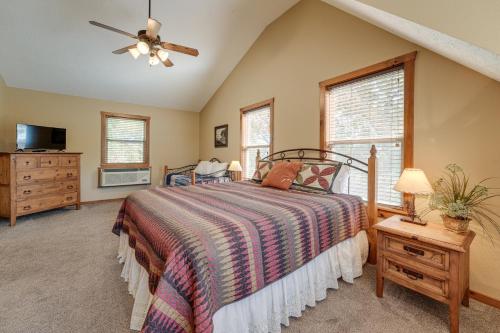 a bedroom with a bed and a ceiling fan at 2 Mi to Silver Dollar City! Spacious A-Frame Home in Branson