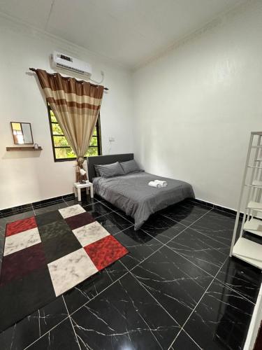 a bedroom with a bed and a window at Rania Riverview Guesthouse in Kuala Berang