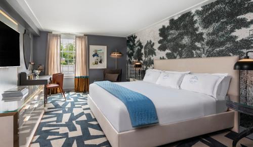 a hotel room with a bed and a desk at The Carolina Inn, a Destination by Hyatt Hotel in Chapel Hill