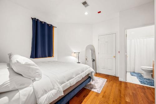 a bedroom with a bed and a bathroom with a sink at Charming Home In Heart of City With King Size Bed! in Philadelphia