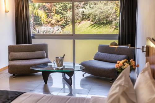 a room with two chairs and a table and a window at Park Hotel in Punta del Este