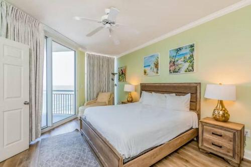 a bedroom with a bed and a large window at Palacio Unit 805 in Pensacola