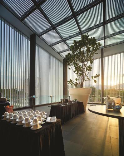 a large room with tables and a large glass ceiling at G Hotel Kelawai in George Town