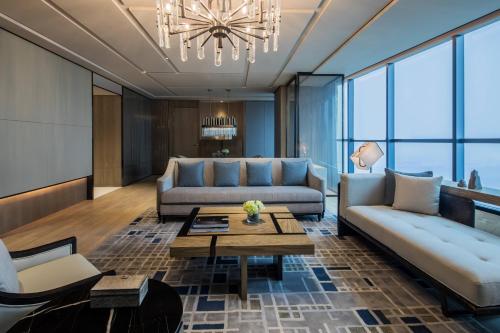 a living room with a couch and a table at Chengdu Marriott Hotel Financial Centre in Chengdu