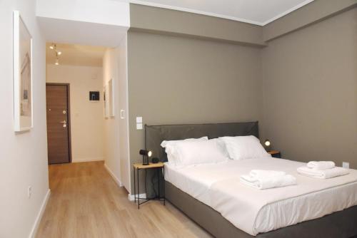 a bedroom with a bed with two towels on it at Athens Benaki 8 Suite in Athens