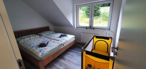 A bed or beds in a room at Apartmán U nás na Dolní Moravě