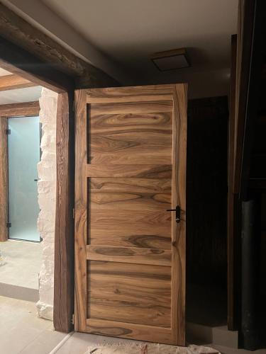 an open wooden door in a room at WELLNESS Chalet OXY in Ždiar