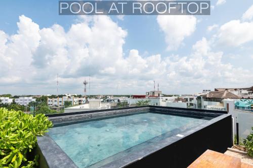 a swimming pool on the roof of a building at IIK Tulum Luxury Condo by Spot Rentals in Tulum