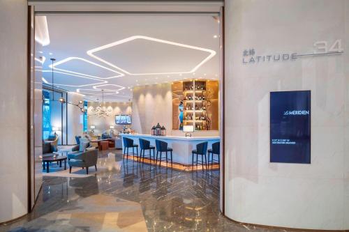 a lobby of a store with a blue table and chairs at Le Meridien Xi'an Chanba in Xi'an