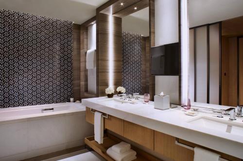 a bathroom with two sinks and a large mirror at The Ritz-Carlton, Xi'an in Xi'an