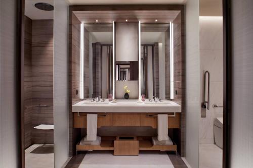 a bathroom with two sinks and a large mirror at The Ritz-Carlton, Xi'an in Xi'an