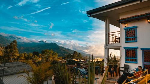 a view from the balcony of a house with mountains in the background at Viajero Salento Hostel in Salento
