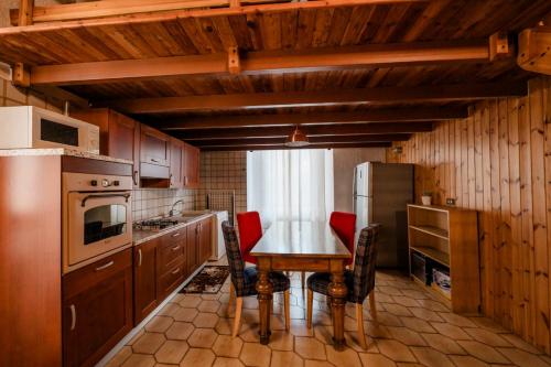 a kitchen with a table and chairs and a refrigerator at P&P Borgo Apartment in Bergamo