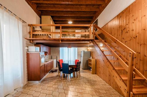 a room with a staircase and a table and chairs at P&P Borgo Apartment in Bergamo